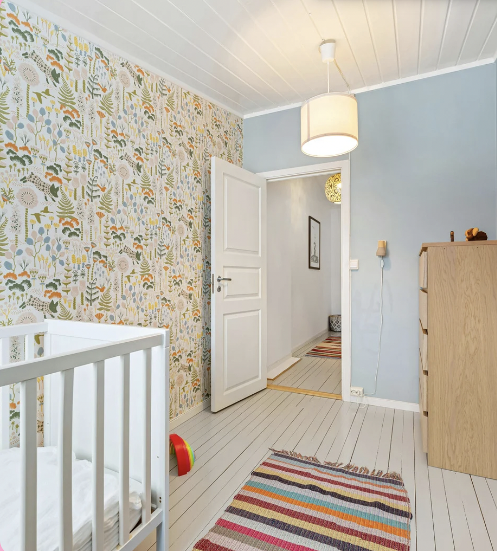 Bright residential room with decorative wallpaper and styled interior details